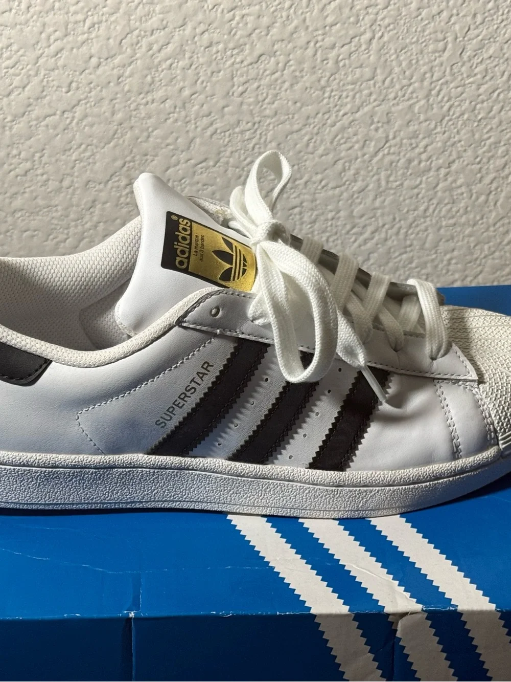 Adidas Superstar Sneakers with Black Stripes and Gold Tongue Logo
